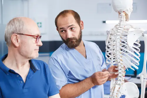 Man Talking to Doctor About Spinal Cord Injury