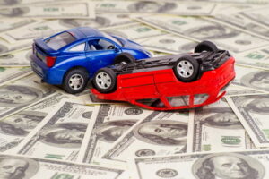average car accident settlement in Georgia, crashed toy cars on money